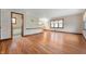 Open living room features hardwood floors and seamless access to a well-lit bathroom at 453 S High School Rd, Indianapolis, IN 46241