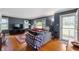 Cozy living room with hardwood floors and ample natural light from surrounding windows at 453 S High School Rd, Indianapolis, IN 46241