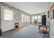 Inviting sun room featuring large windows, carpet, and a door to the exterior at 453 S High School Rd, Indianapolis, IN 46241