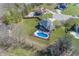 Aerial view showcasing a property with a backyard oasis, featuring an in-ground pool and mature trees at 4644 S Grassy Ct, New Palestine, IN 46163
