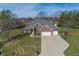 Beautiful aerial view of a brick home featuring a well-manicured lawn, in-ground pool and ample parking at 4644 S Grassy Ct, New Palestine, IN 46163