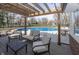 Inviting back patio with stylish furniture, pergola and an in-ground pool creating a perfect space for outdoor relaxation and entertainment at 4644 S Grassy Ct, New Palestine, IN 46163