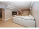 Finished basement featuring a large sectional sofa and a brick accent wall at 4644 S Grassy Ct, New Palestine, IN 46163