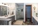 Stylish bathroom featuring a modern vanity, framed mirror, step-in shower, and tiled floor at 4644 S Grassy Ct, New Palestine, IN 46163