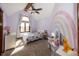 Charming bedroom with rainbow wall art, arched window, and ceiling fan at 4644 S Grassy Ct, New Palestine, IN 46163