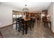 Open dining area features modern light fixture, table with seating for six, and hardwood floors at 4644 S Grassy Ct, New Palestine, IN 46163
