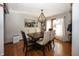 Dining room featuring a modern light fixture and a dark wood table with seating at 4644 S Grassy Ct, New Palestine, IN 46163