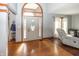 Bright foyer featuring hardwood floors, coat rack, and a glimpse of the living room at 4644 S Grassy Ct, New Palestine, IN 46163