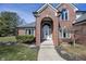 Close up of brick home's front door and archway, including Welcome decoration at 4644 S Grassy Ct, New Palestine, IN 46163