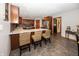 Open kitchen features wood cabinets, granite countertops, a breakfast bar, and stainless appliances at 4644 S Grassy Ct, New Palestine, IN 46163