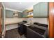 Laundry room boasts modern washer and dryer, ample cabinet space, and tiled floors at 4644 S Grassy Ct, New Palestine, IN 46163