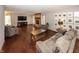 Inviting living room with hardwood floors, a brick fireplace, and wall decor at 4644 S Grassy Ct, New Palestine, IN 46163