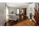 Comfortable living room featuring hardwood floors, chair, and adjacent staircase at 4644 S Grassy Ct, New Palestine, IN 46163