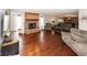 Spacious living room with hardwood floors, a brick fireplace, and comfortable seating at 4644 S Grassy Ct, New Palestine, IN 46163