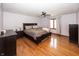 Spacious main bedroom featuring neutral walls, ceiling fan, wood floors, and natural light at 4644 S Grassy Ct, New Palestine, IN 46163
