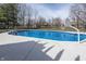 Backyard in-ground pool with basketball hoop, perfect for summertime fun and recreation in a private setting at 4644 S Grassy Ct, New Palestine, IN 46163