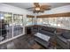 Relaxing sunroom with ceiling fan, tiled floors, and comfortable seating with a view of the pool at 4644 S Grassy Ct, New Palestine, IN 46163