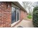 Brick exterior with a sliding glass door providing access to the backyard at 5061 Sylvan Rd, Indianapolis, IN 46228