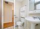 Bathroom boasts a classic pedestal sink, storage cabinet, and a tiled floor at 5061 Sylvan Rd, Indianapolis, IN 46228