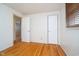 Bedroom featuring hardwood floors and access to other areas of the home at 5061 Sylvan Rd, Indianapolis, IN 46228