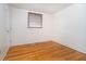 Bedroom featuring hardwood floors and a window with blinds for natural light at 5061 Sylvan Rd, Indianapolis, IN 46228