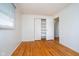 Bedroom featuring hardwood floors, a closet, and views into the home at 5061 Sylvan Rd, Indianapolis, IN 46228