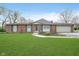 Charming one-story brick home with a well-manicured lawn and attached two-car garage at 5061 Sylvan Rd, Indianapolis, IN 46228