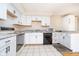 Bright kitchen with ample white cabinets, countertops, and modern appliances at 5061 Sylvan Rd, Indianapolis, IN 46228