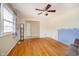 Bright living room featuring hardwood floors, ceiling fan, and lots of natural light at 5061 Sylvan Rd, Indianapolis, IN 46228