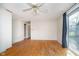 Spacious living area with hardwood floors, ceiling fan, and sliding glass doors for natural light at 5061 Sylvan Rd, Indianapolis, IN 46228