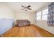 Spacious living room with hardwood floors, fan, many windows and a comfortable couch at 5061 Sylvan Rd, Indianapolis, IN 46228