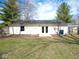 A beautiful backyard featuring a spacious lawn and a home with a small patio at 5523 Epperson Ct, Indianapolis, IN 46221