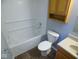 A bathroom with a combined bathtub and shower, wood cabinets, and vinyl flooring at 5523 Epperson Ct, Indianapolis, IN 46221