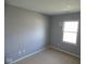 A bright bedroom featuring neutral carpet, gray walls and a sunlit window at 5523 Epperson Ct, Indianapolis, IN 46221