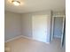 Comfortable bedroom is freshly painted and carpeted with a closet, ready for personalization and relaxation at 5523 Epperson Ct, Indianapolis, IN 46221