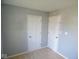 Neutral carpeted bedroom shows two white doors and light gray walls at 5523 Epperson Ct, Indianapolis, IN 46221