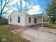 Charming single-story home featuring light yellow siding and a convenient carport at 5523 Epperson Ct, Indianapolis, IN 46221