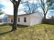 Single-story home featuring light yellow siding, a driveway, and green grass at 5523 Epperson Ct, Indianapolis, IN 46221