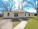 Inviting single-story home features a cheerful yellow exterior with a covered front porch and well-maintained lawn at 5523 Epperson Ct, Indianapolis, IN 46221