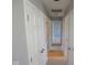 Hallway with multiple doors leading to bedrooms or bathrooms, facilitating easy navigation throughout the home at 5523 Epperson Ct, Indianapolis, IN 46221