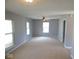 Spacious living room is illuminated by natural light through large windows and ceiling fan, perfect for relaxation at 5523 Epperson Ct, Indianapolis, IN 46221