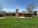 This property features a nice backyard with mature trees and a brick chimney at 5630 S Cladwell Dr, Pendleton, IN 46064