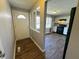Entryway leading to a modern kitchen with new cabinetry, granite counters, and black appliances at 5630 S Cladwell Dr, Pendleton, IN 46064