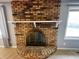 Close-up of an impressive brick fireplace with a decorative screen and white mantle at 5630 S Cladwell Dr, Pendleton, IN 46064