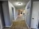Long hallway with fresh gray paint and neutral carpet lead to other rooms in the home at 5630 S Cladwell Dr, Pendleton, IN 46064