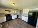 Modern kitchen with new white cabinetry, granite counters, and new black appliances at 5630 S Cladwell Dr, Pendleton, IN 46064