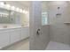Bathroom featuring a glass shower with tile surround, and double sinks with ample counter space at 5653 Stetson Dr, Whitestown, IN 46052