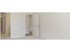 Bright bedroom entryway with neutral walls and light carpeting that leads to the hallway at 5653 Stetson Dr, Whitestown, IN 46052