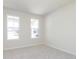 Bright, carpeted bedroom featuring white trim, two windows, and neutral walls at 5653 Stetson Dr, Whitestown, IN 46052