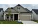Charming single-story home with neutral siding, a two-car garage, and manicured front lawn and classic architectural details at 5653 Stetson Dr, Whitestown, IN 46052